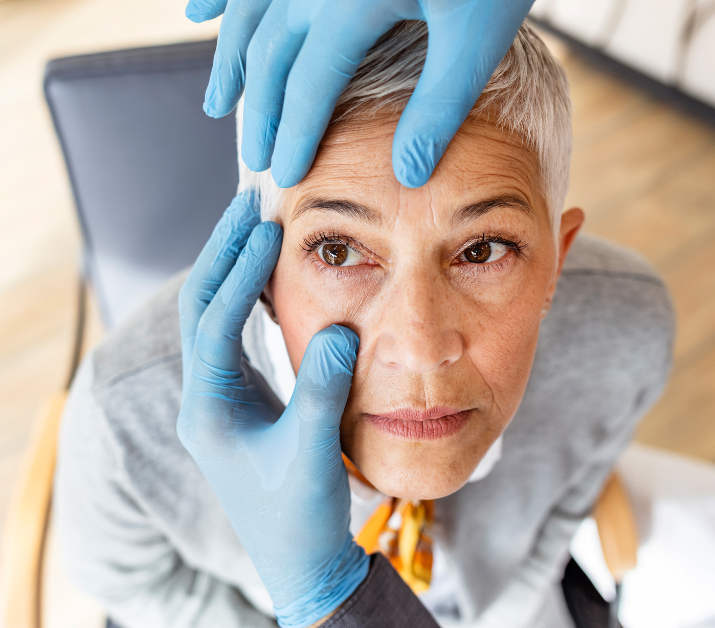 Senior patient having an eye exam at ophthalmologist's office Portrait of a happy mature male patient undergoing vision check with special ophthalmic glasses